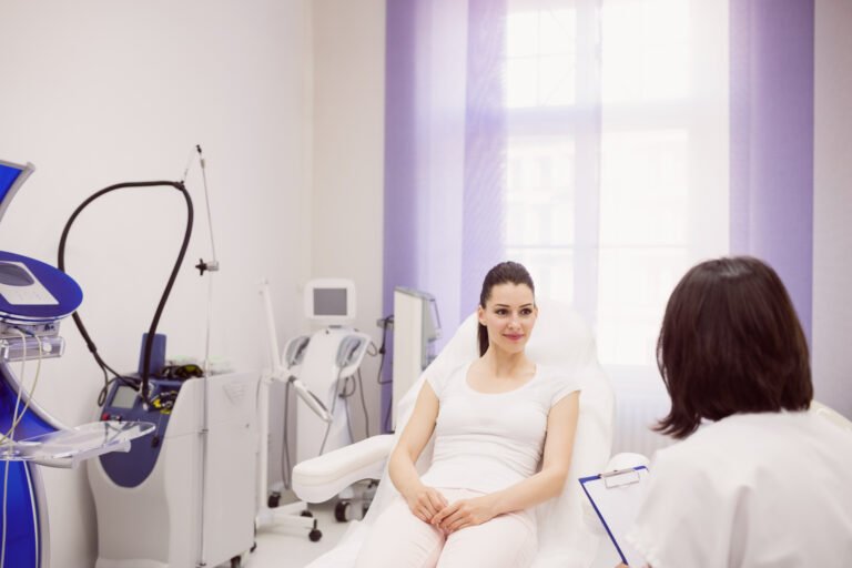 Dermatologist and female patient interacting with each other in clinic