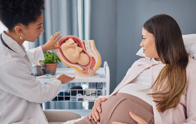 pregnant-woman-doctor-explanation-with-fetus-clinic-medical-expertise-progress-assessment-baby-pregnancy-mom-with-black-woman-gynaecologist-update-growth-development